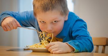 A child eating pasta