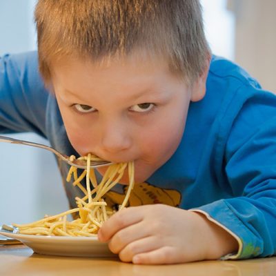 A child eating pasta